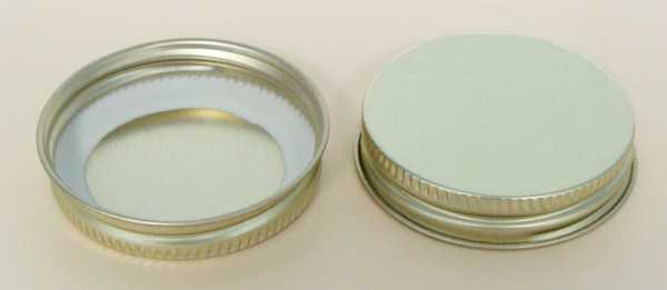 38-400 WHITE THREADS, KNURLS, & CURL TIN-PLATE STEEL TIN-PLATE STEEL CONTINUOUS THREAD (CT) CAP WITH PLASTISOL LINER