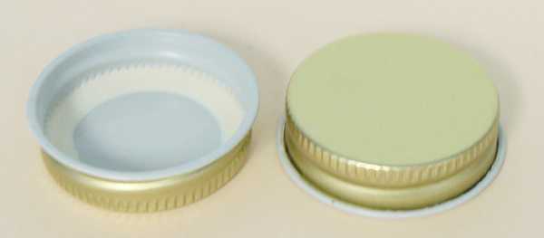 38-400 WHITE THREADS, KNURLS, & CURL TIN-PLATE STEEL TIN-PLATE STEEL CONTINUOUS THREAD (CT) CAP WITH PLASTISOL LINER